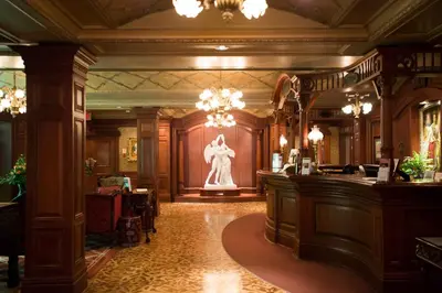 a lobby with a statue in the center of a building at Prince of Wales in Niagara on the Lake
