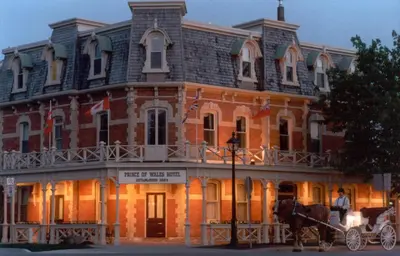 a horse drawn carriage in front of a large building at Prince of Wales in Niagara on the Lake