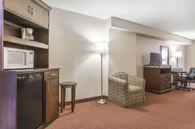 a hotel room with a kitchen and a living room at Econo Lodge in Orillia