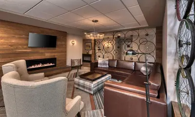 a living room with a couch and a fireplace at Four Points by Sheraton Barrie in Barrie