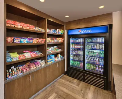 a grocery store aisle with a soda vending machine at Four Points by Sheraton Barrie in Barrie