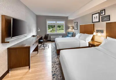 a hotel room with two beds and a flat screen tv at Four Points by Sheraton Barrie in Barrie