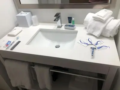 a white sink in a bathroom with a mirror at Four Points by Sheraton Barrie in Barrie