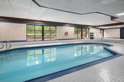 a large swimming pool in a building with a large pool at Travelodge by Wyndham Barrie in Barrie