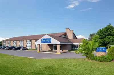 a large building with a sign in front of it at Travelodge by Wyndham Barrie in Barrie