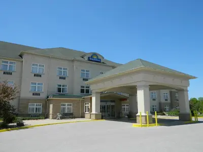 a hotel building with a parking lot in front of it at Days Inn by Wyndham Orillia in Orillia