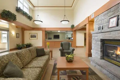 a living room with a couch and a fireplace at Days Inn by Wyndham Orillia in Orillia