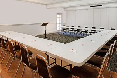 a row of tables in a room with chairs at Howard Johnson by Wyndham Lindsay in Lindsay