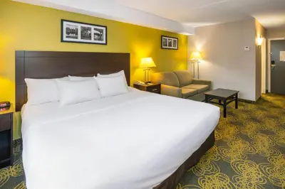 a large white bed in a hotel room at Comfort Hotel & Suites in Peterborough