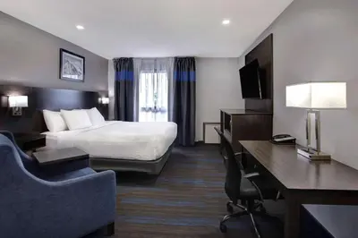 a hotel room with a bed and a desk at Days Inn by Wyndham Barrie in Barrie