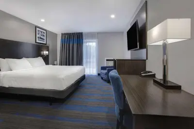 a hotel room with a bed and a desk at Days Inn by Wyndham Barrie in Barrie