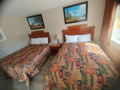 a hotel room with two beds and a window at Relax Inn-Collingwood in Collingwood