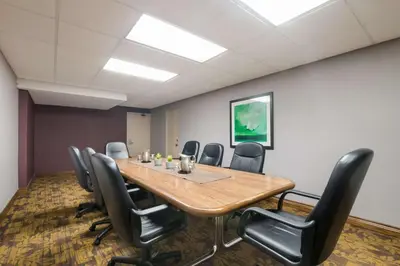 a conference room with a wooden table and chairs at Best Western St Catharines Hotel & Conference Centre in St. Catharines