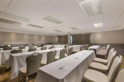 a conference room with white tables and chairs at Best Western St Catharines Hotel & Conference Centre in St. Catharines