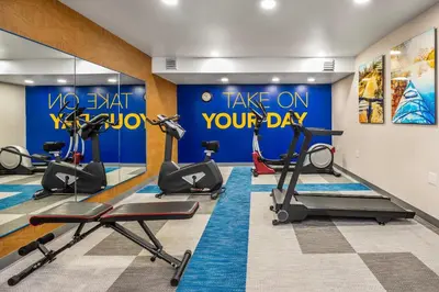 a gym with cardio equipment and a sign that says take on your day at Comfort Inn & Suites in Barrie