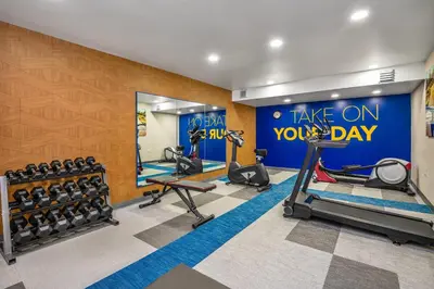 a gym with cardio equipment and a sign that reads take on your day at Comfort Inn & Suites in Barrie