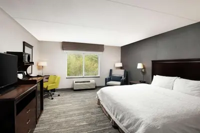 a hotel room with a bed and a television at Hampton Inn & Suites by Hilton Barrie in Barrie