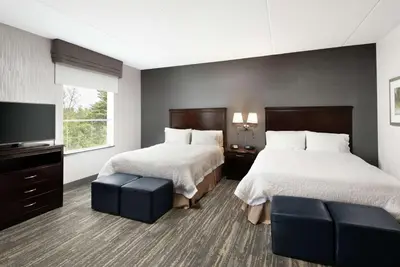 a hotel room with two beds and a flat screen tv at Hampton Inn & Suites by Hilton Barrie in Barrie