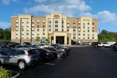 a large building with cars parked in a parking lot at Hampton Inn & Suites by Hilton Barrie in Barrie