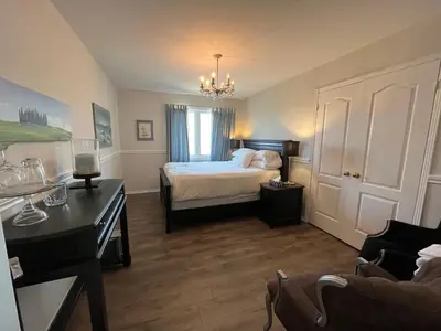 a bedroom with a bed and a desk in a room at Lulu's Bed & Breakfast in Niagara on the Lake
