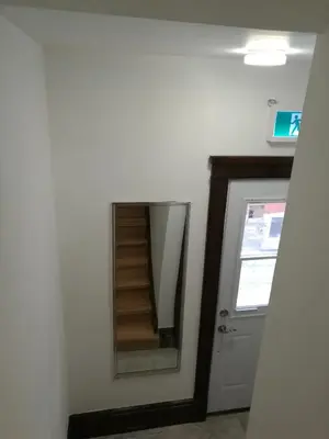 a stairwell in a room with a mirror at Ambassador's Inn Next Door in Stratford