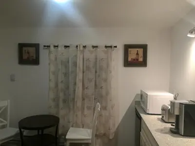 a kitchen with a shower curtain and a microwave at Ambassador's Inn Next Door in Stratford