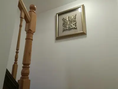 a picture hanging on a wall next to a stairway at Ambassador's Inn Next Door in Stratford