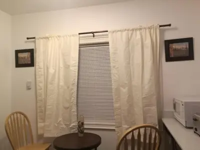 a dining room with a table and a window at Ambassador's Inn Next Door in Stratford