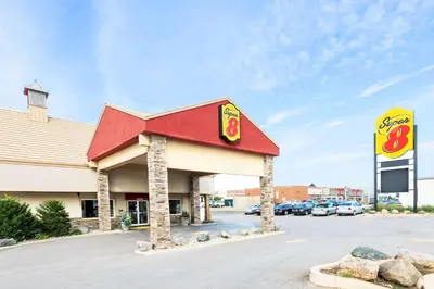 a mcdonalds restaurant with a sign in a parking lot at Super 8 by Wyndham Cambridge/Kitchener/Waterloo Area in Cambridge