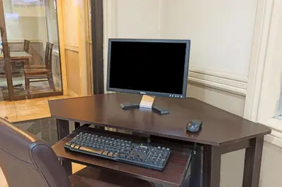 a computer monitor and keyboard on a wooden desk at Super 8 by Wyndham Cambridge/Kitchener/Waterloo Area in Cambridge