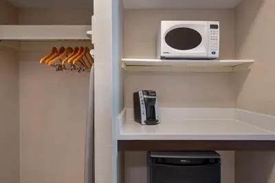 a small kitchen with a microwave and a stove at Holiday Inn Express Hotel & Suites Barrie by IHG in Barrie