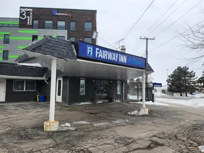 a gas station with a sign on top of it at Fairway Inn & Suites in Kitchener