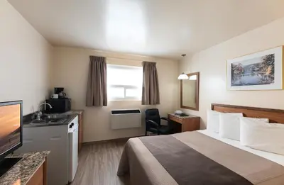 a hotel room with a bed and a television at Newmarket Inn in Newmarket