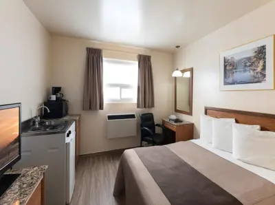 a hotel room with a bed and a television at Newmarket Inn in Newmarket