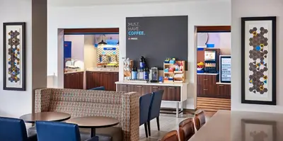 a restaurant with tables and chairs and a counter at Holiday Inn Express & Suites - Brantford by IHG in Brantford