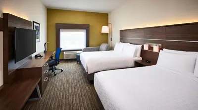 a hotel room with two beds and a desk with a television at Holiday Inn Express & Suites - Brantford by IHG in Brantford
