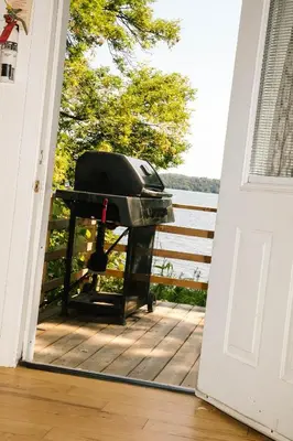 a grill sitting on the porch of a house at Elmhirst's Resort in Keene