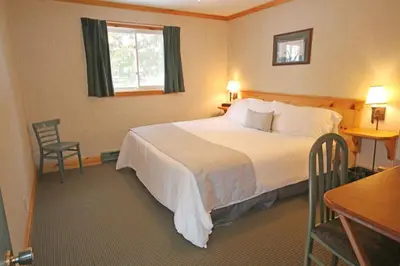 a hotel room with a bed and a table and chairs at Elmhirst's Resort in Keene