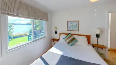 a bedroom with a bed and a large window at Elmhirst's Resort in Keene