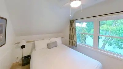 a bedroom with a white bed and a window at Elmhirst's Resort in Keene