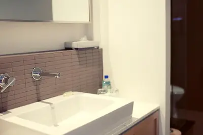 a bathroom with a white sink and a mirror at Hotel Ocho in Toronto