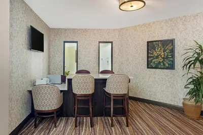 a waiting room with a table and chairs at Best Western Plus Otonabee Inn in Peterborough