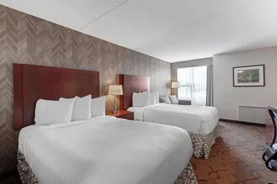 a hotel room with two beds and a window at Best Western Plus Otonabee Inn in Peterborough