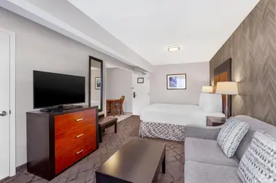 a hotel room with a bed and a flat screen tv at Best Western Plus Otonabee Inn in Peterborough