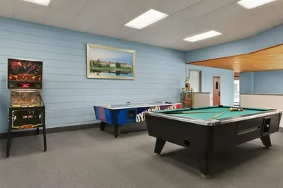 a billiard room with two pool tables in it at Ramada by Wyndham Belleville Harbourview Conference Center in Belleville