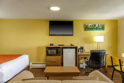 a hotel room with a bed a desk and a tv at Motel 6 Campbellford, ON in Campbellford