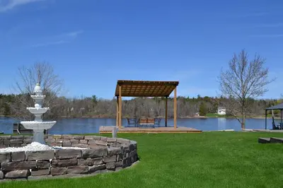 a park with a gazebo next to a lake at Motel 6 Campbellford, ON in Campbellford