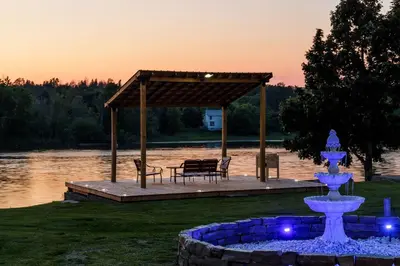 a gazebo with a fountain and a table and chairs at Motel 6 Campbellford, ON in Campbellford