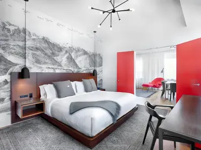 a bedroom with a large bed and a dining room at The Walper Hotel, part of JdV by Hyatt in Kitchener