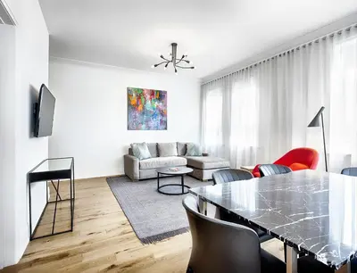 a white living room with a glass table and chairs at The Walper Hotel, part of JdV by Hyatt in Kitchener